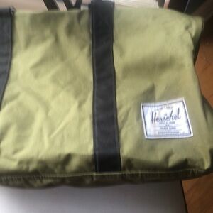 Herschel olive green canvas travel‎ bag. Zippered outside pocket on one end